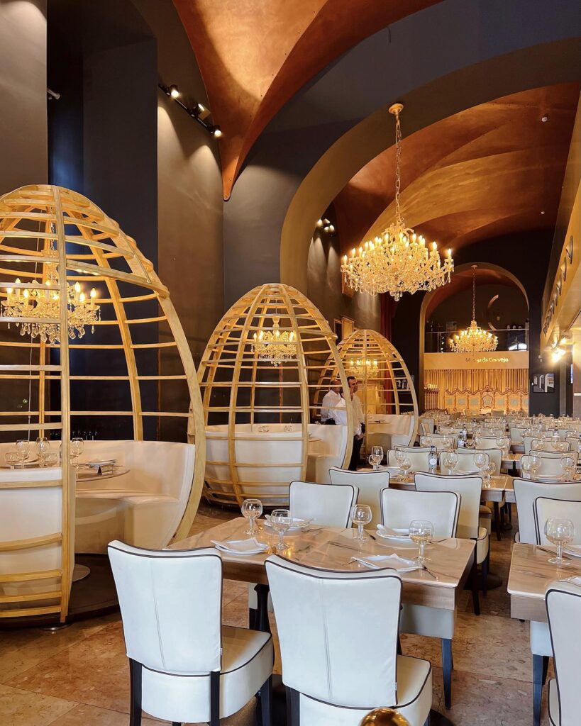 Praça do Comércio (Terreiro do Paço) in Lisbon 9 Luxurious dining space in Lisbon featuring cozy, cocoon-like booths, elegant chandeliers, and stylish decor, perfect for a memorable culinary experience in the heart of Lisbon.