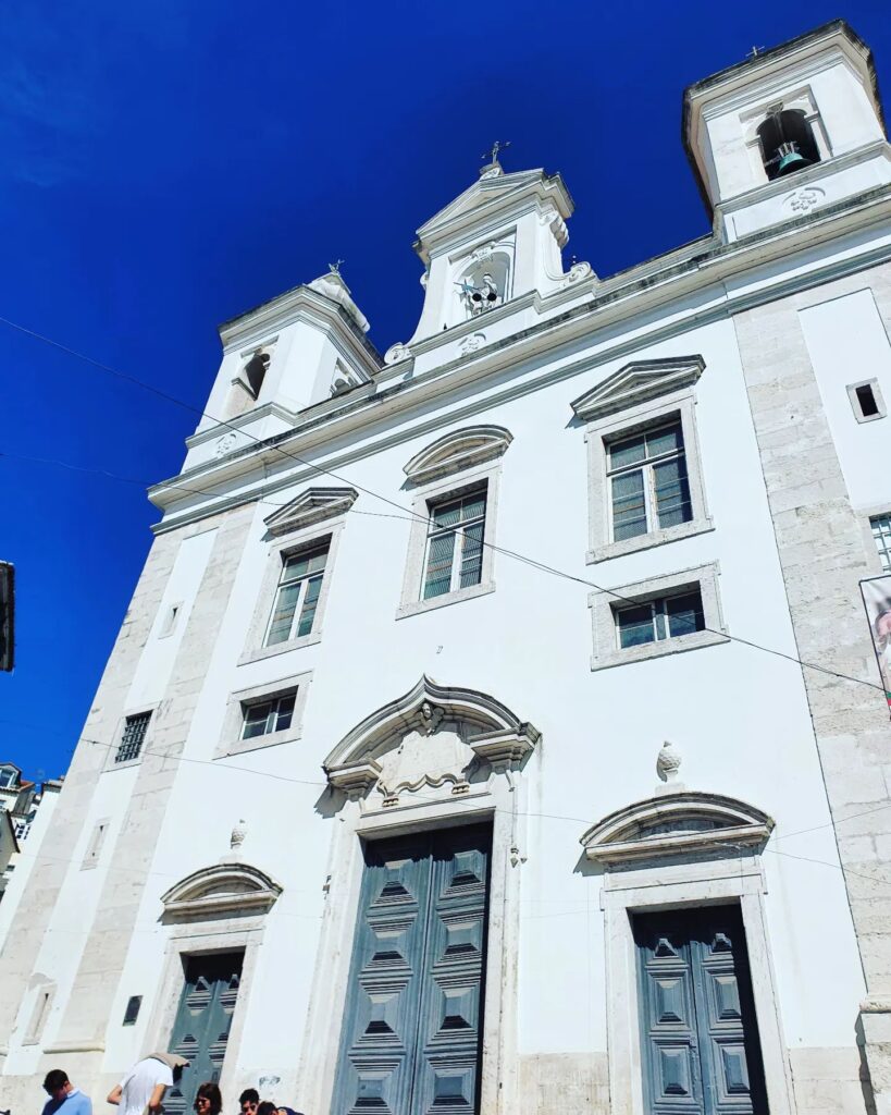 Alfama in Lisbon: A Tourist Guide 17 Alfama Church in Lisbon with its historic white facade and baroque architecture, a key landmark in the Alfama district, showcasing Portugal's rich cultural heritage.