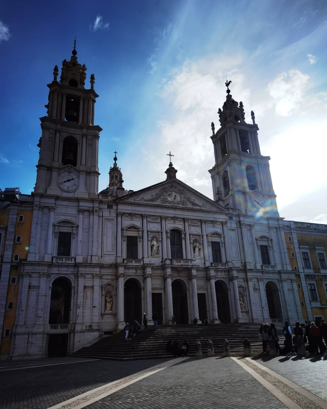 21 Amazing Castles in Lisbon and Its Surroundings 13 Majestic Lisbon Cathedral with iconic twin towers and baroque architecture, set against a vibrant blue sky, highlighting Lisbon tourism and historic landmarks.