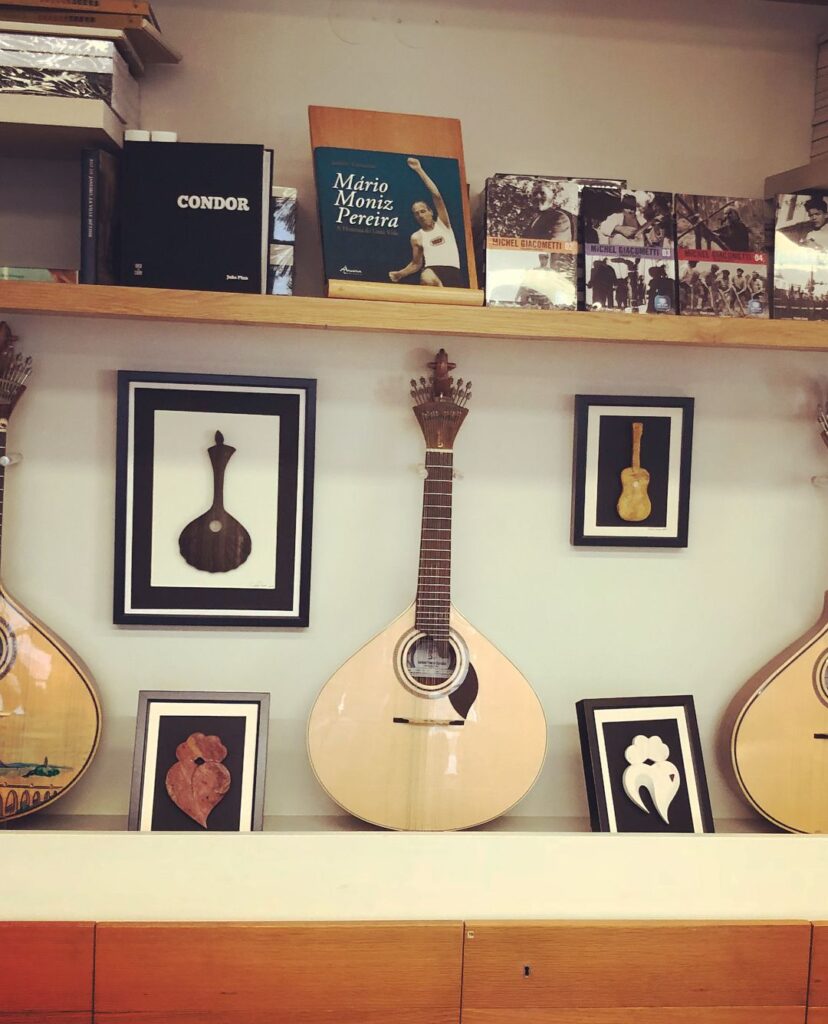 Alfama in Lisbon: A Tourist Guide 13 Elegant guitar artwork with framed illustrations in a cozy Lisbon shop.