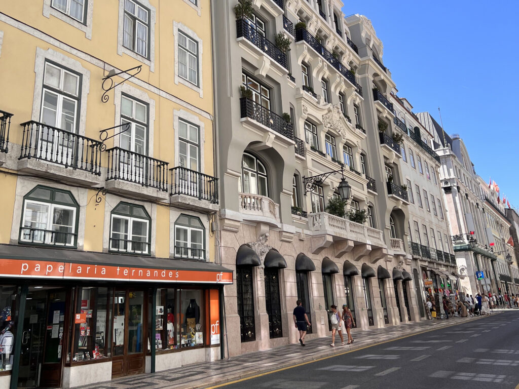 Lisbon Neighborhoods: Local's Guide to Where to Visit 3 Beautiful Lisbon street with historic buildings and vibrant city atmosphere.
